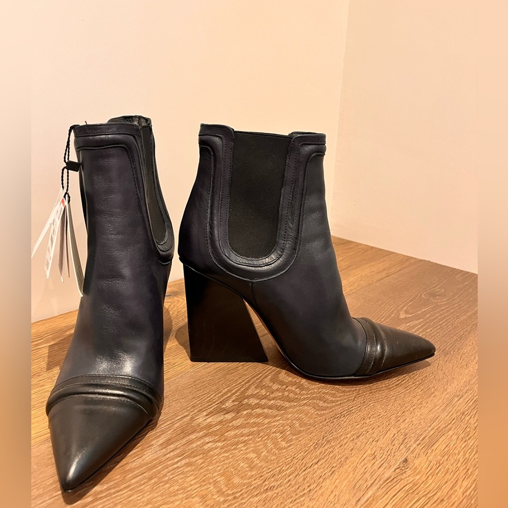 Blue leather with black toe Chelsea boots with sculptural wedge heel.